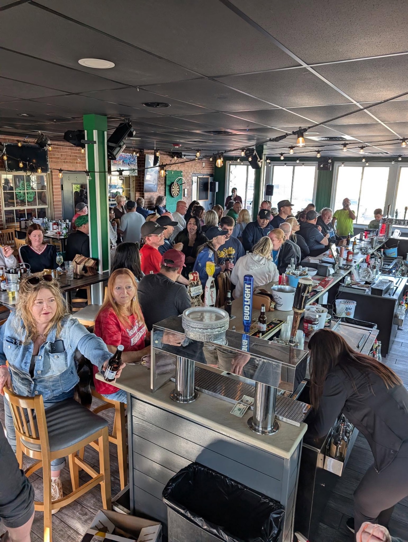 A lively afternoon crowd gathered around the bar at Mayfair Bar and Grill